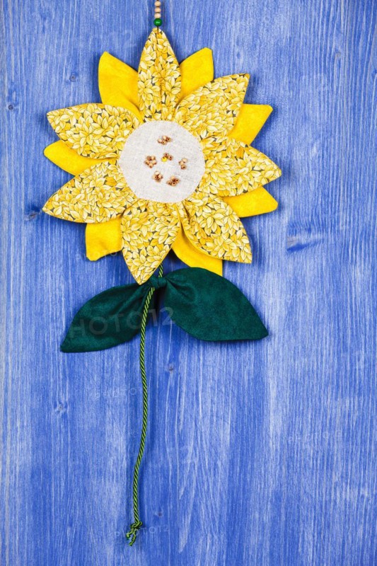 Fabric sunflower on blue background