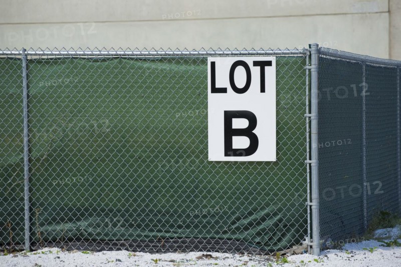Sign on a chain-link fence reading