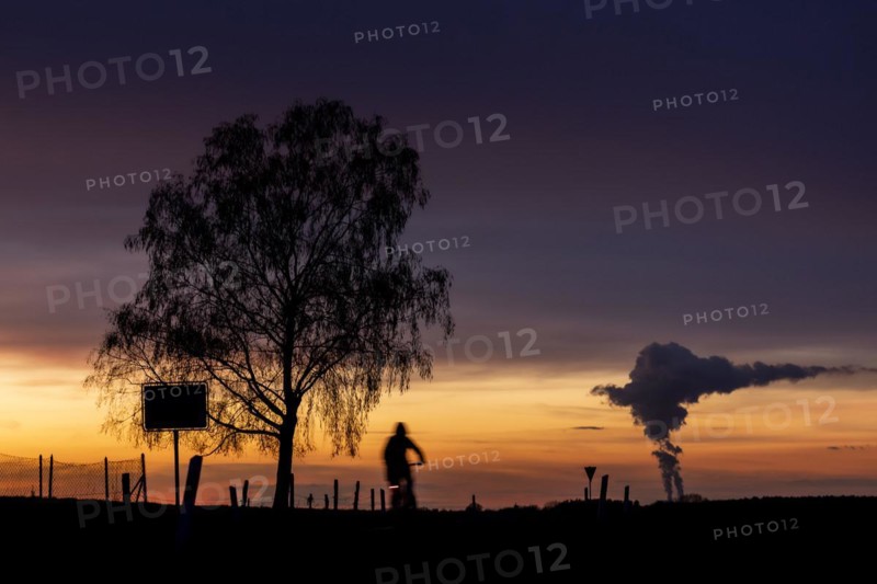 The Schwarze Pumpe coal-fired power plant looms in the evening twilight near Ober-Prauske