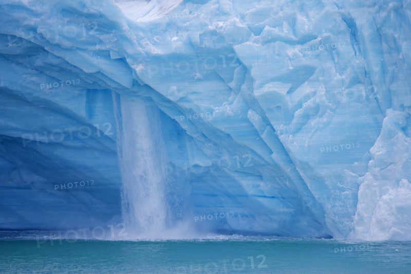 Waterfall at edge of the Brasvellbreen glacier from the ice cap Austfonna debouching into the Barents Sea