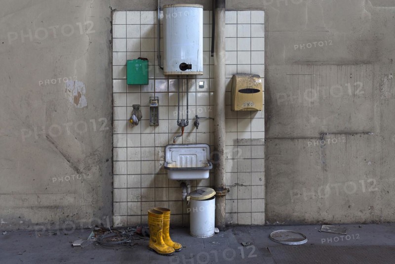 Hand basin with instantaneous water heater in a factory hall in a former paper factory