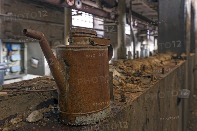 Rusty oil can in a former paper factory
