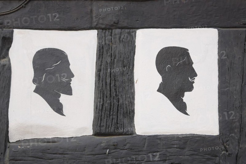 Two men's hairstyles at the half-timbered house of the hairdresser's salon
