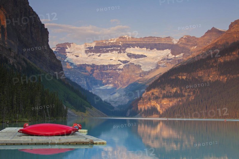 Red canoes at glacial Lake Louise with Victoria glacier