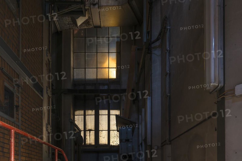 Window to the staircase in the powerhouse of a former paper factory