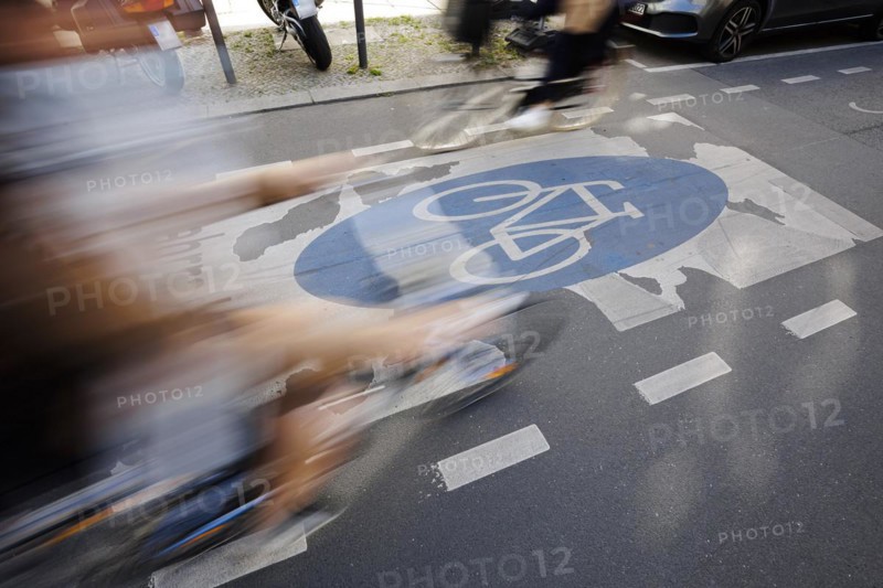 Symbolic photo on the subject of bicycle lanes in the city. Cyclists ride on the bicycle street in Linienstrasse in Berlin Mitte. Berlin