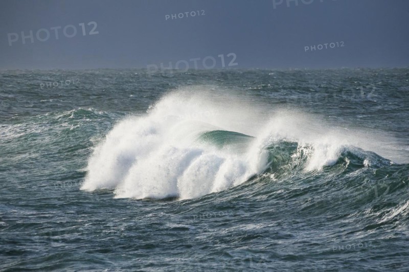 Big wave breaks in the open sea on the Breton coast near Brest
