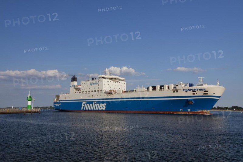 Ro-ro passenger ferry Finnpartner from Finnlines passing lighthouse Travemuende Nordmole