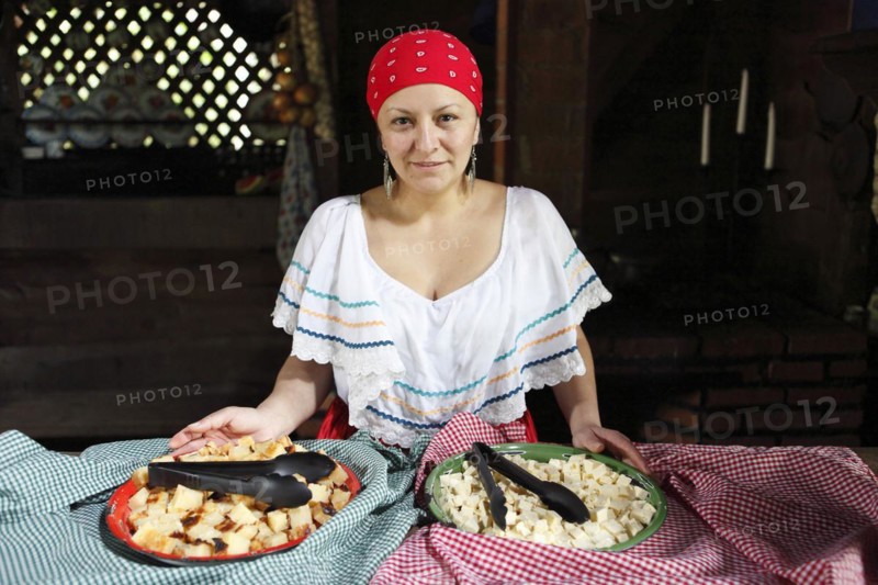 Costa Rican woman with corn pudding tamale asado and homemade cheese CaseroI