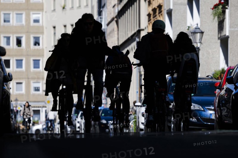 Symbolic photo on the subject of bicycle lanes in the city. Cyclists ride on the bicycle street in Linienstrasse in Berlin Mitte. Berlin