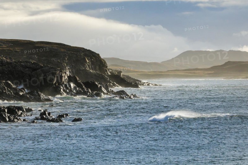Atmospheric light on the stormy rocky coast of western Scotland