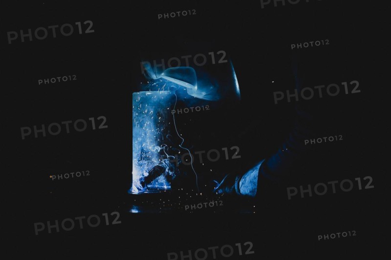 A metal worker welds metal