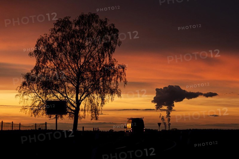 The Schwarze Pumpe coal-fired power plant looms in the evening twilight near Ober-Prauske