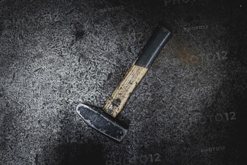 A hammer lying on a workbench