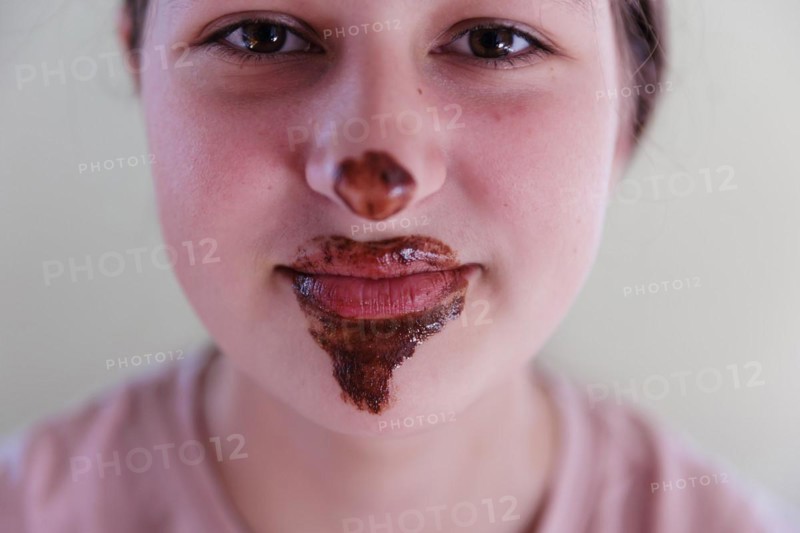 Girl with a chocolate-smeared mouth