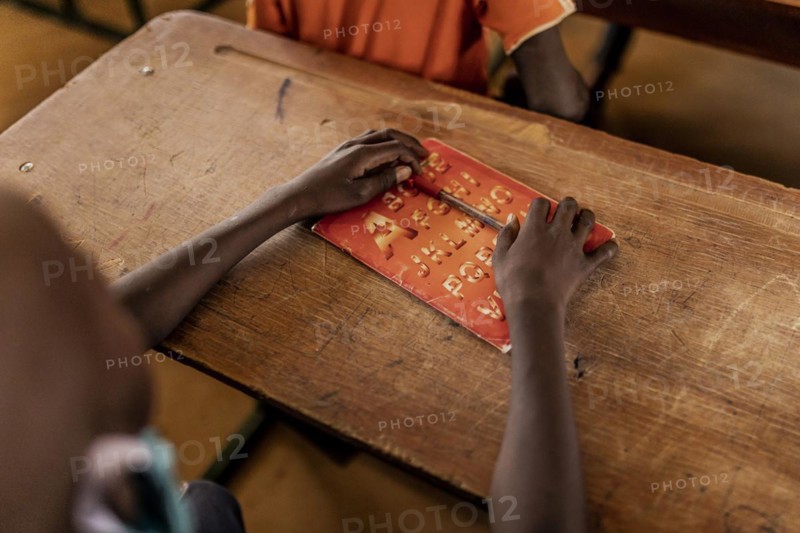 Child in a school class in a settlement for refugees