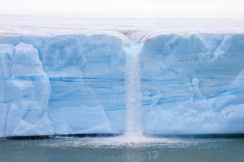 Waterfall at edge of the Brasvellbreen glacier from the ice cap Austfonna debouching into the Barents Sea