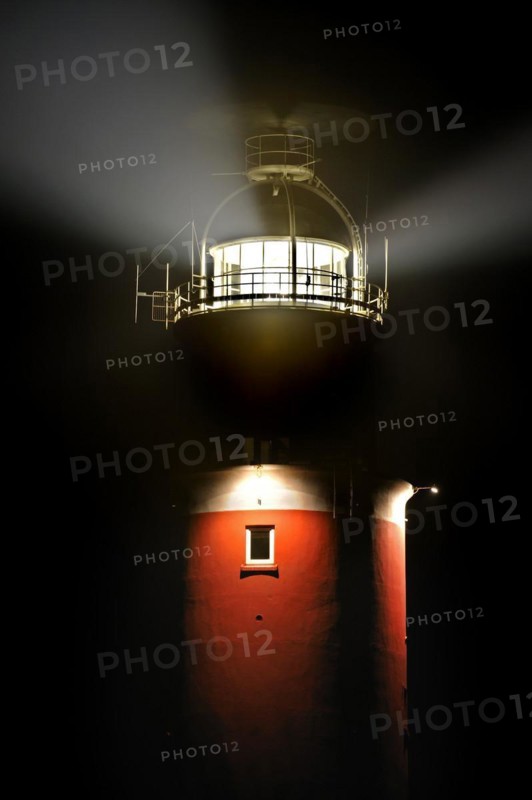 Light beams from lantern of the Cocksdorp lighthouse Eierland at night