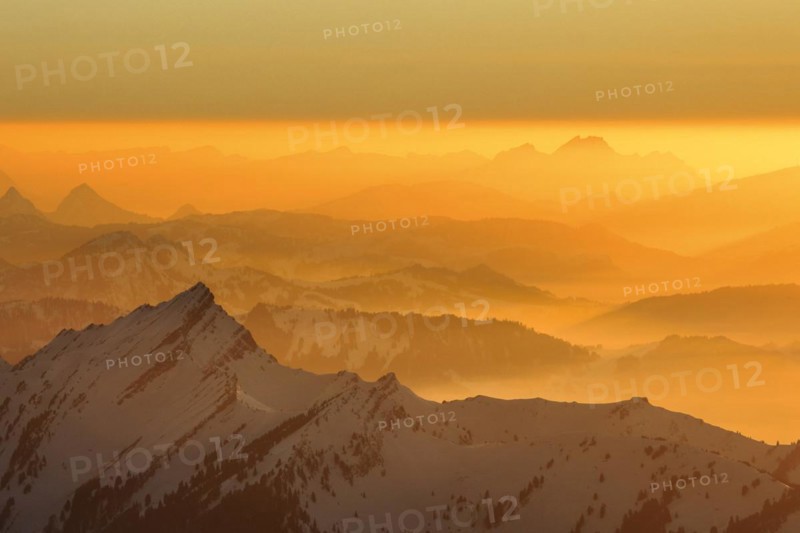 Golden sunset in winter with view from Saentis to Pilatus in Central Switzerland