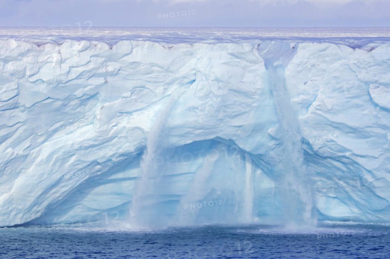Waterfalls at edge of the Brasvellbreen glacier from the ice cap Austfonna debouching into the Barents Sea