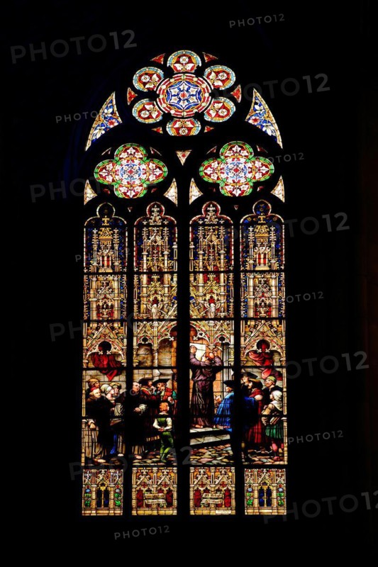 Stained glass window with Martin Luther's posting of 95 theses at the castle church in Wittenberg