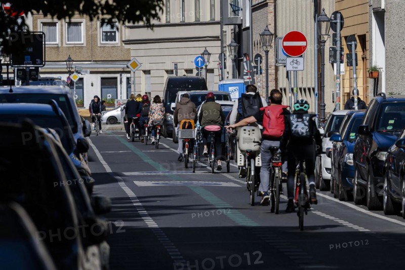 Symbolic photo on the subject of bicycle lanes in the city. Cyclists ride on the bicycle street in Linienstrasse in Berlin Mitte. Berlin