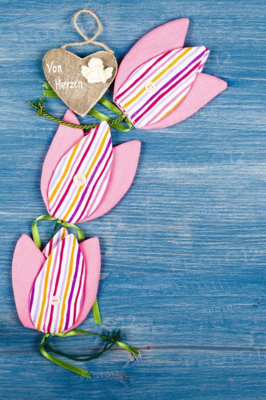 Three fabric tulips on a blue background
