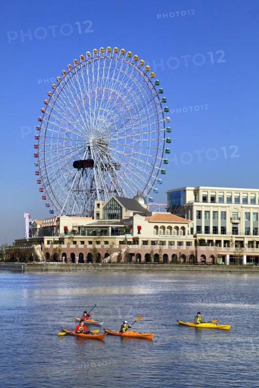 Group of kayaks on excursion and Ferris Wheel Cosmo Clock 21 of Yokohama Cosmo World in background Yokohama city Kanagawa Japan