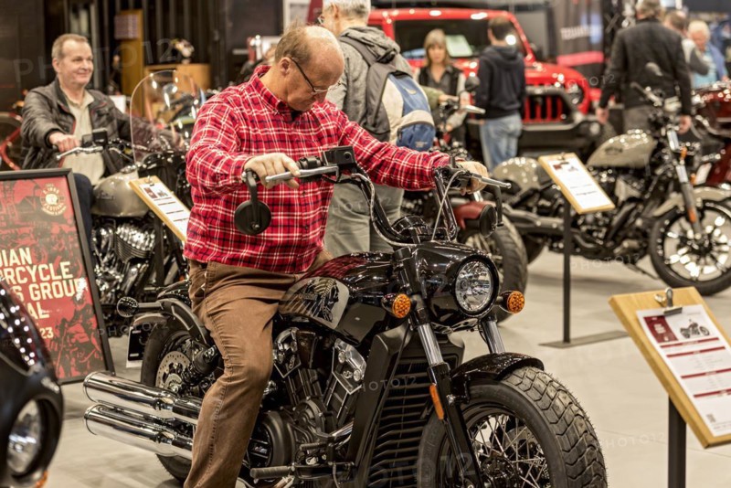 Man sits test on motorbike Indian Scout Bobber Twenty