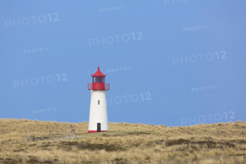 Red and white List-West lighthouse in the dunes on the island Sylt
