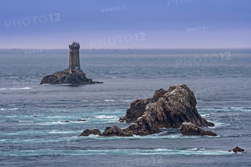 The lighthouse La Vieille in the strait Raz de Sein at dusk at the Pointe du Raz