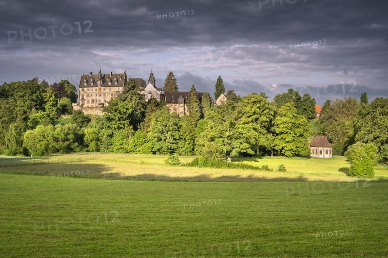 Eisenbach Castle and Annen Chapel under dark clouds