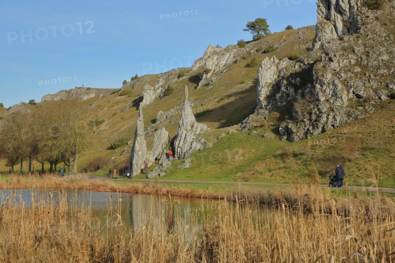 Eselsburg Valley with bizarre rock formations of the Stone Maidens and walkers