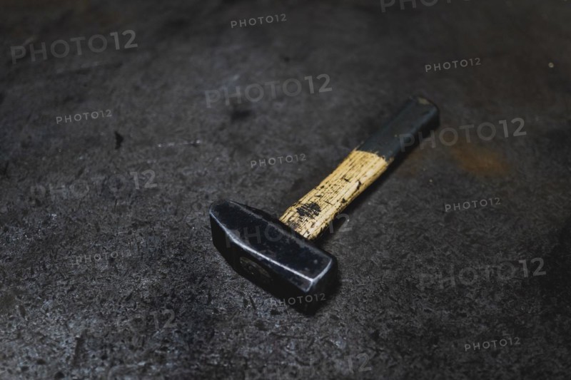A hammer lying on a workbench