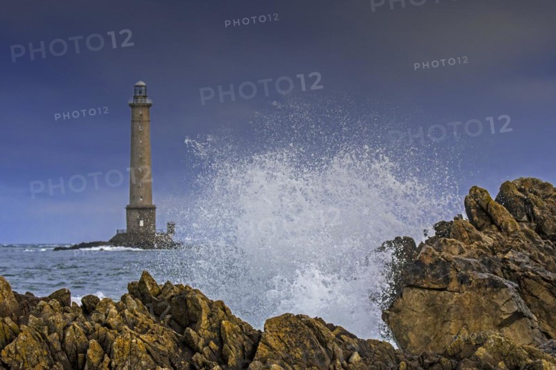 Wave crashing on rock and Phare de La Hague
