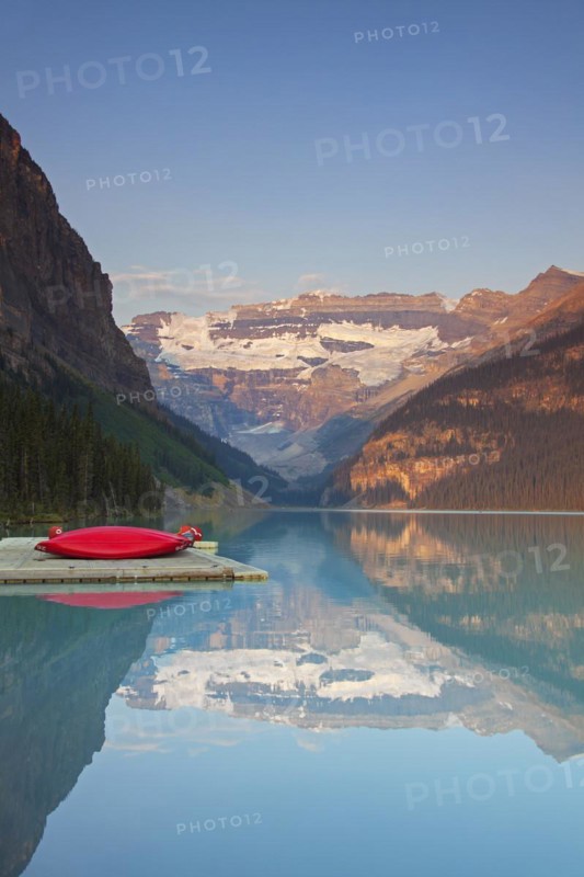 Red canoes at glacial Lake Louise with Victoria glacier