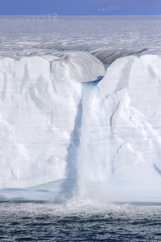 Waterfall at edge of the Brasvellbreen glacier from the ice cap Austfonna debouching into the Barents Sea