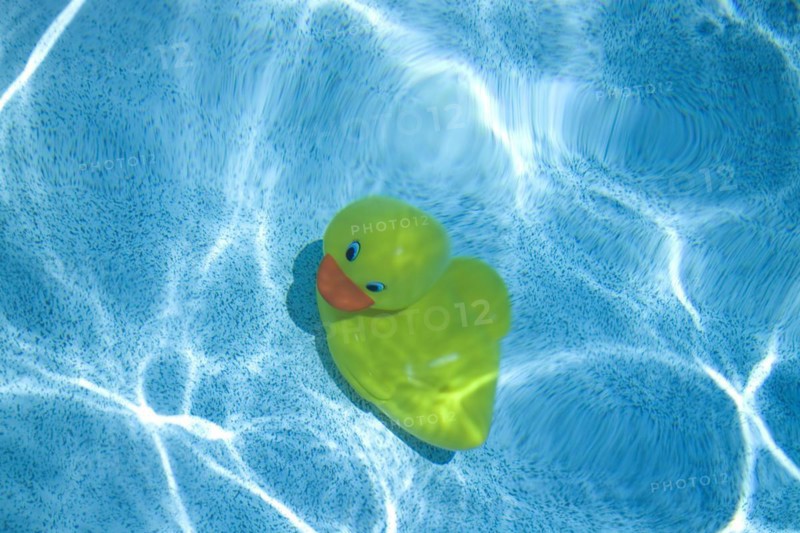 Yellow rubber duck at the bottom of pool