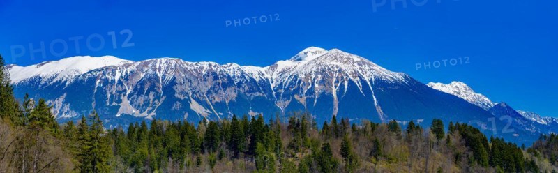 Snow-covered Alps behind Lake Bled