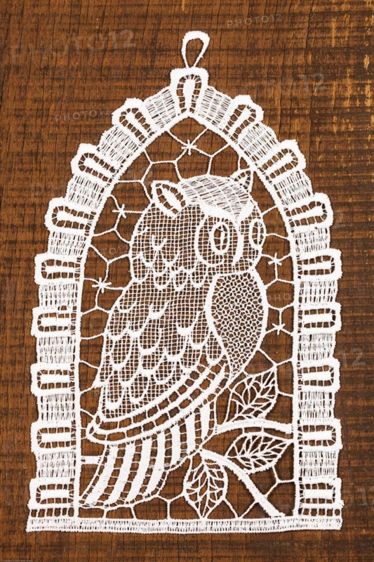 Crocheted owl on wooden background