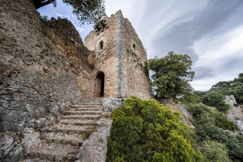 Stone steps and tower of the castle ruins Castell Alaro