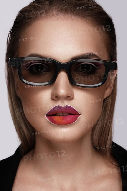 Beautiful caucasian woman with creative makeup and purple lips. Beauty face. Art makeup