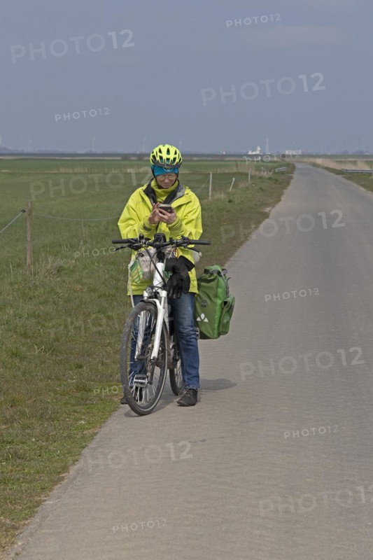 Cyclist checking her mobile phone