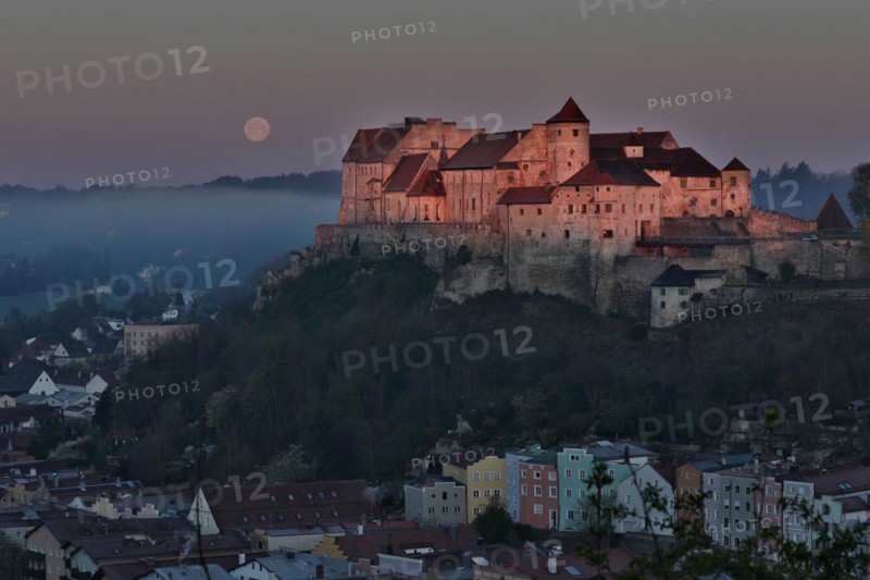 The castle in Burghausen in the first light of the morning above the historic old town