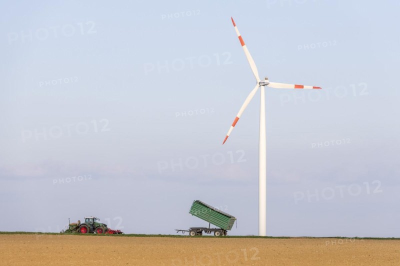 Tractor with trailer sowing grain in a field
