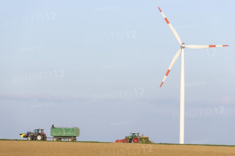 Tractor with trailer sowing grain in a field