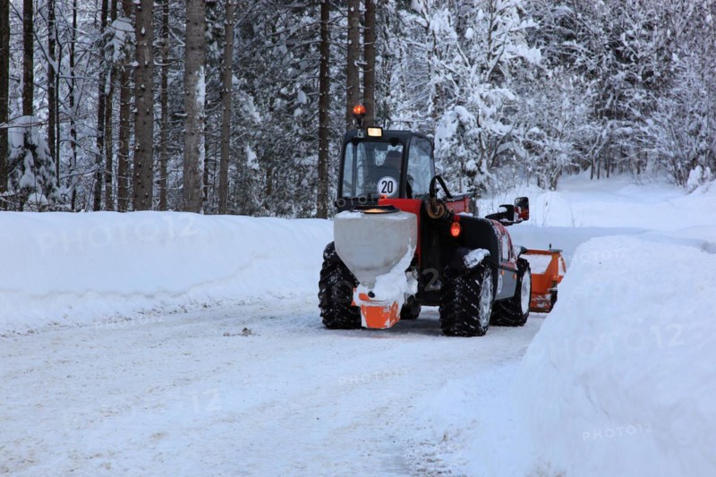 Winter service with snow plough on a country road in Upper Bavaria