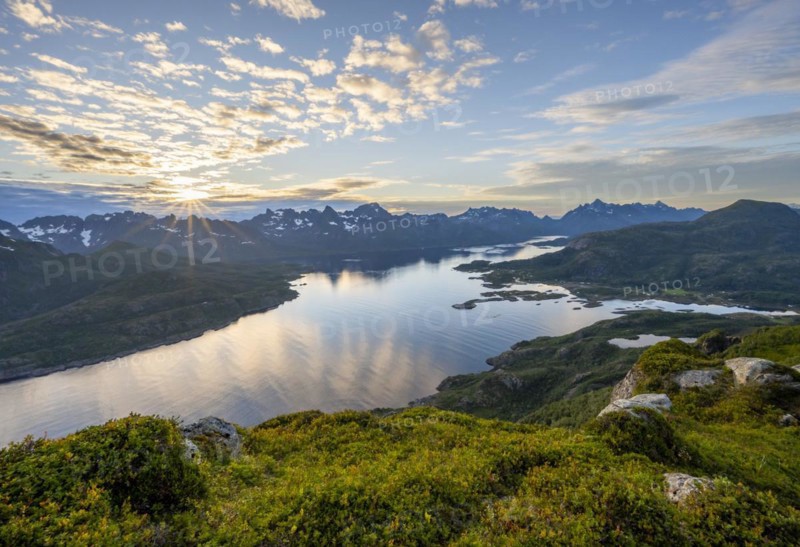 Sun star at sunset over the mountain peaks