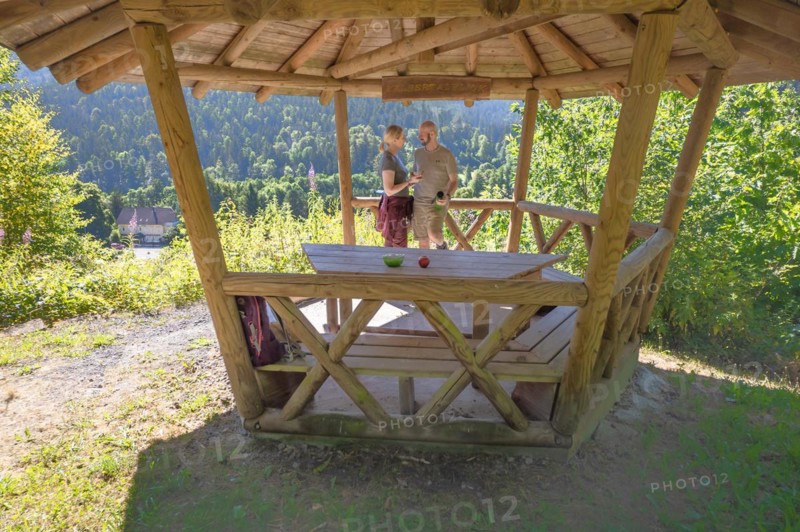 Hiking couple taking a break in wooden pavilion on the hiking trail Sprollenhaeuser Hut