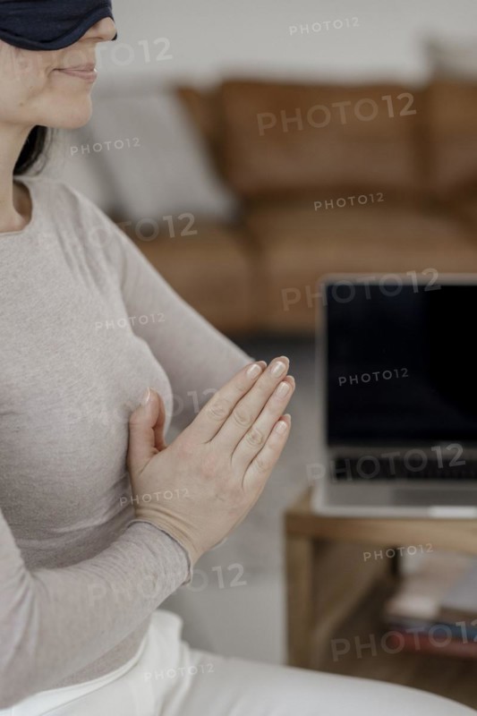 Woman sitting on chair doing a relaxation exercise